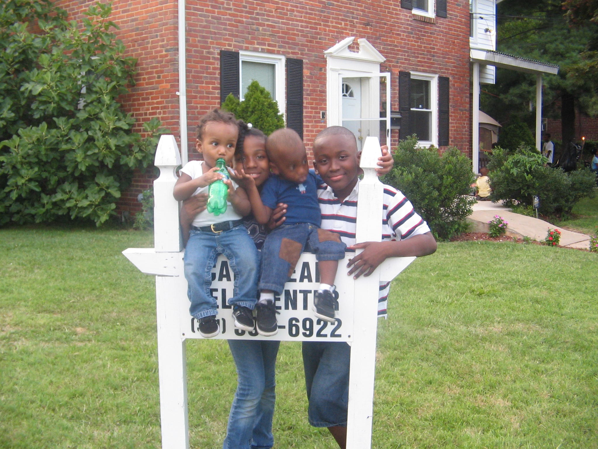 Community member seated outdoors in front of a house