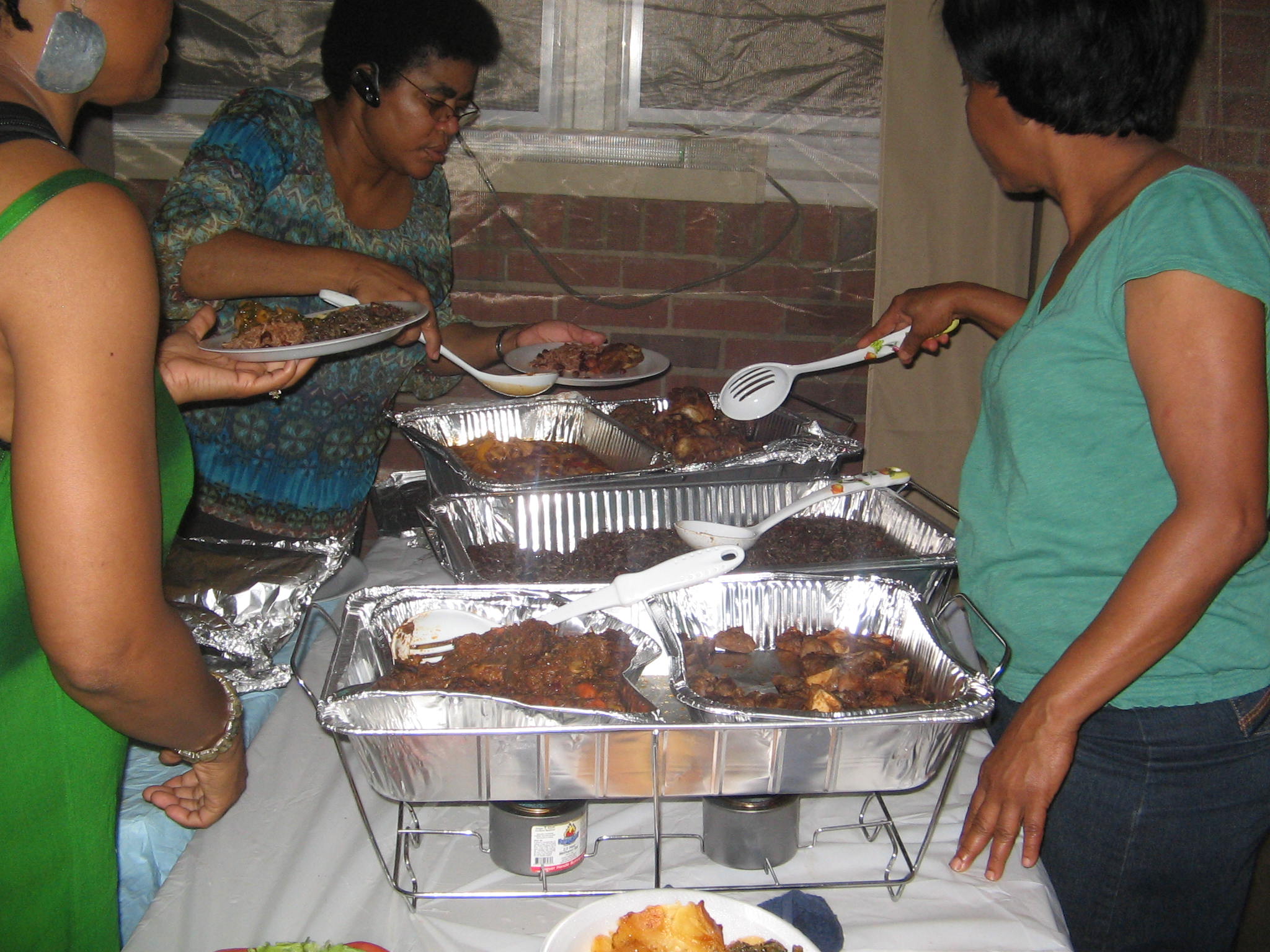 Community members meeting with volunteers during a service event